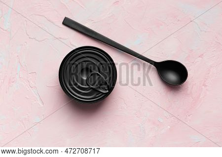 Black Matte Round Closed Tin Can And Black Spoon On Texture Background Top View, Tinned Food, Canned