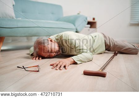 Asian Senior Man Falling On The Ground With Walker In Living Room At Home. Elderly Older Mature Male