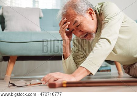 Asian Senior Man Falling On The Ground With Walker In Living Room At Home. Elderly Older Mature Male