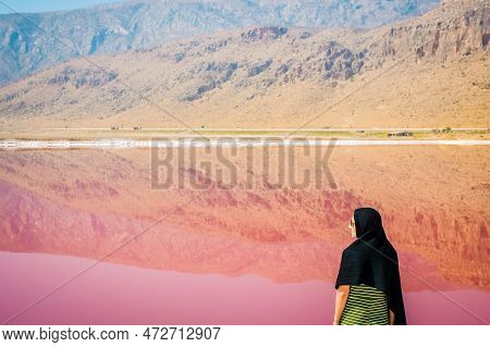 Caucasian Woman Tourist Stand On Maharlu Pink Salt Lake Shore. Travel Destination Iran In Shiraz