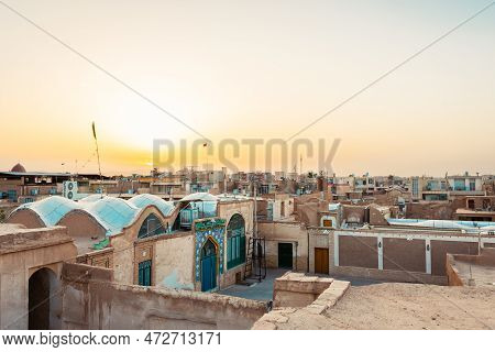 Kashan, Iran - 10th June, 2022: Woman Tourist Enjoy Kashan City Buildings Rooftops Background With S