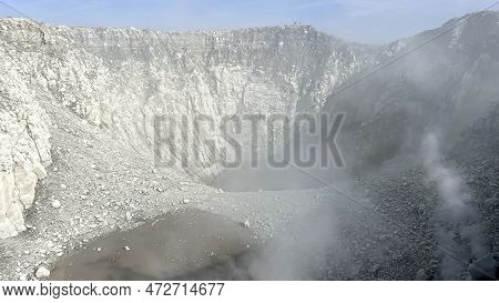 Seeing The Inside Of A Volcano Crater With Smoke In East Java, Indonesia. Aerial View Of Volcano Cra