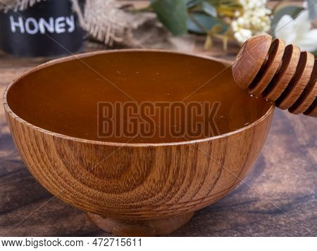 Honey Spoon Coming Out Of The Bowl Full Of Honey. Honey Contains Many Nutrients, Antioxidants, Impro