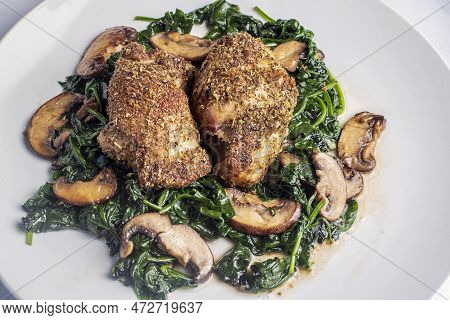 Bone Less  Chicken Thighs  Served With Sauteed Spinach And Mushrooms.