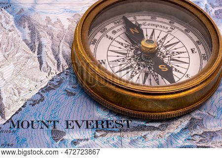 Close Up Of Vintage Brass Compass On Map Detail Of Mt. Everest Topographical Map Showing Contour Lin