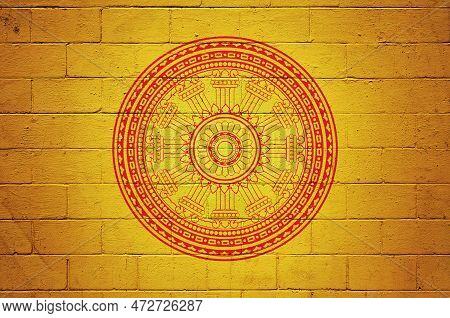 Flag Of The Dharmacakra Painted On A Cinder Block Wall.