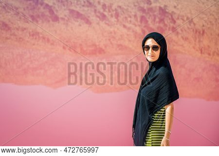 Caucasian Woman Tourist Stand On Maharlu Pink Salt Lake Shore With Reflections. Travel Destination I