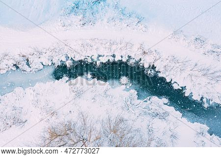 Amazing Aerial View On Freezing River. Aerial View Flight Above Frozen Creek. Scenic View Of Nature.