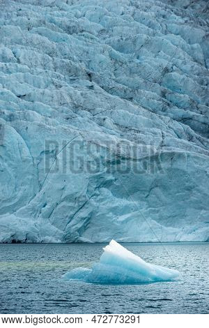 Chunk Of Glacier Ice Lit By Rising Sun Folgefonna Glacier Mosevatnet Lake, Norway