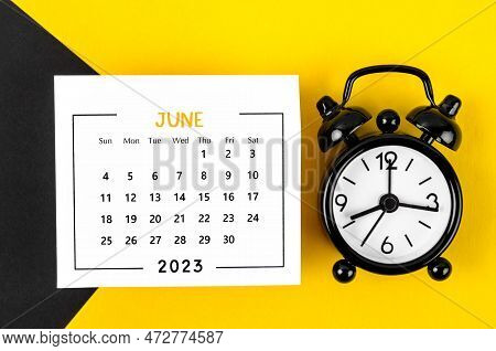 June 2023 Monthly Calendar For 2023 Year With Black Colour Alarm Clock On Beautiful Background.