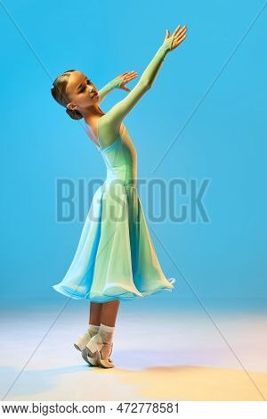 Valse. Portrait Of Little Flexible Girl In Stage Outfit, Dress Dancing Ballroom Dance Over Blue Back