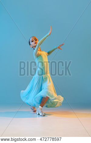 Valse. Portrait Of Little Flexible Girl In Stage Outfit, Dress Dancing Ballroom Dance Over Blue Back