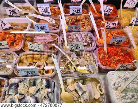 Katowice, Poland - December 9, 2022: Various Types Of Pickled Herrings And Herring Salads With Price