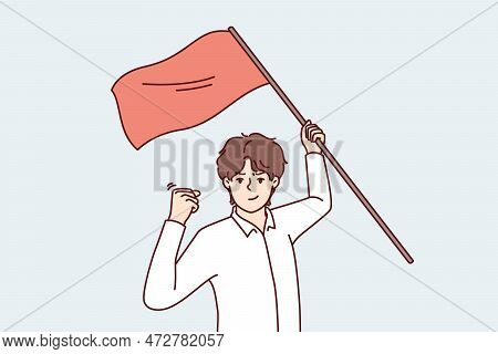 Man With Red Flag In Hand Makes Victory Gesture Showing Leadership Qualities And Motivating People. 