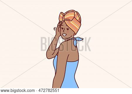 Charming African American Woman With Traditional Turban On Head Is Dressed In Blue Dress For Going T