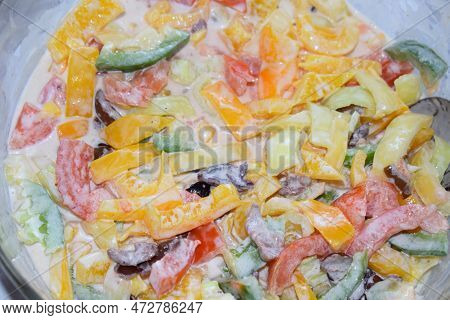 Colorful Salad From Paprika, Tomato, Olives And Yogurt Sauce