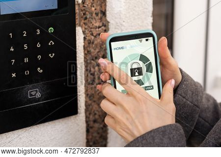 Young Stylish Woman Getting Access To The Building By Attaching Smartphone To Intercom. Concept Of M