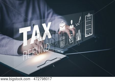 Businessman Using A Pen To Write A Notebook With Tax Refund And Refund Tax Of Duty Taxation Business