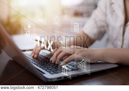 Hand Using A Laptop With Tax Refund And Refund Tax Of Duty Taxation Business, Graphs And Chart Being