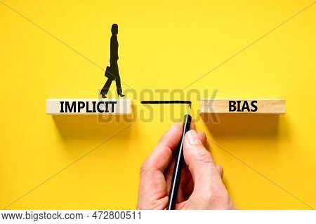 Implicit Bias Symbol. Concept Words Implicit Bias On Wooden Block. Beautiful Yellow Table Yellow Bac