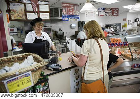 Hurricane, Usa - July 17, 2008: Supermarket Employees In A Supermarket Selling Sandwiches And Sweets