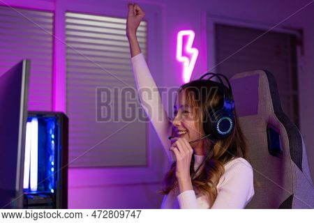 Asian Gamer Playing Online Video Game Winning Excited On Pc With Lighting Effect, Broadcast Streamin