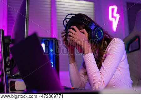 Asian Gamer Playing Online Video Game Winning Excited On Pc With Lighting Effect, Broadcast Streamin