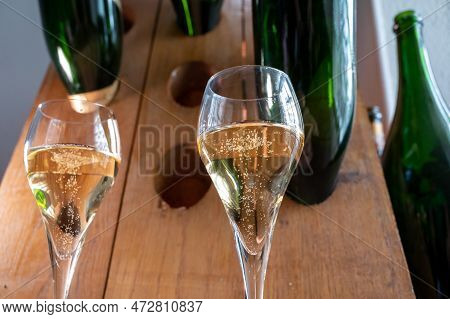 Glasses Of Sparkling White Wine Champagne Or Cava With Bubbles And Classic Wooden Champagne Pupitre