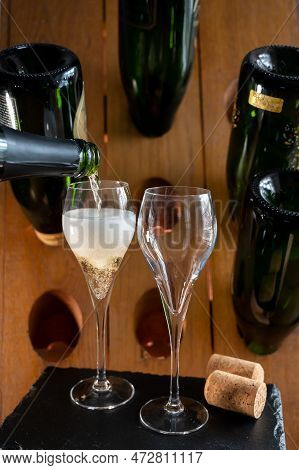 Glasses Of Sparkling White Wine Champagne Or Cava With Bubbles And Classic Wooden Champagne Pupitre