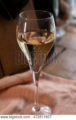 Glass Of Sparkling White Wine Champagne Or Cava With Bubbles And Classic Wooden Champagne Pupitre Ra
