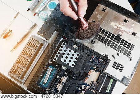 Repaiman With Brush Is Cleaning Disassembled Laptop Parts. Technical Support And Fixing Gadgets Prob