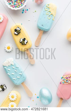 Top Down View Of Several Homemade Cakesicles, Decorated For Easter.