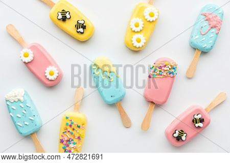 Top Down View Of Several Homemade Cakesicles Decorated For Spring And Easter.
