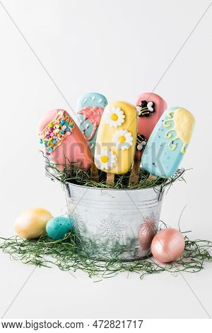 Homemade Cakesicles Decorated For Easter, In A Tin Pail.