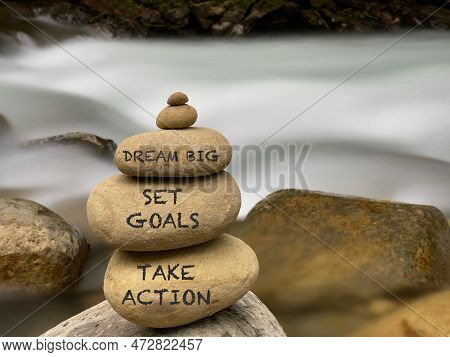 Inspirational Quote Concept - Dream Big Set Goals Take Action Text On Pebbles Background. Stock Phot