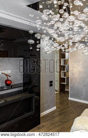 Black Bio Fireplace In The Living Room With Large Crystal Chandelier In The Apartment
