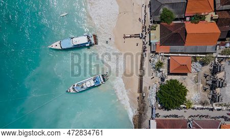 Aerial Shoreline View Of Jungutbatu Beach At Nusa Lembongan With Tourist Speedboat Anchored. One Of 