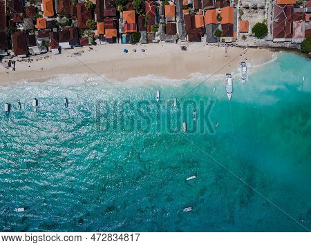Aerial Shoreline View Of Jungutbatu Beach At Nusa Lembongan With Tourist Speedboat Anchored. One Of 