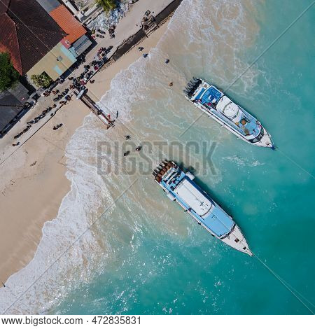 Aerial Shoreline View Of Jungutbatu Beach At Nusa Lembongan With Tourist Speedboat Anchored. One Of 