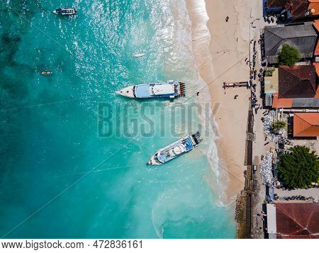 Aerial Shoreline View Of Jungutbatu Beach At Nusa Lembongan With Tourist Speedboat Anchored. One Of 