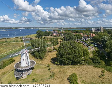 Aerial View With The Windmill De Koe In Veere. In The Background The Inland Water Veerse Meer And Ci
