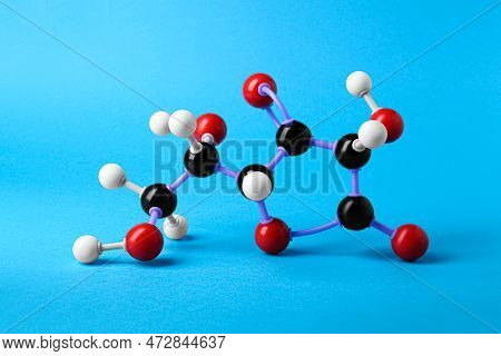 Molecule Of Vitamin C On Light Blue Background. Chemical Model