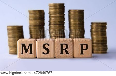 Msrp - Acronym On Wooden Cubes On The Background Of Stacks Of Coins. Manufacturer's Suggested Retail