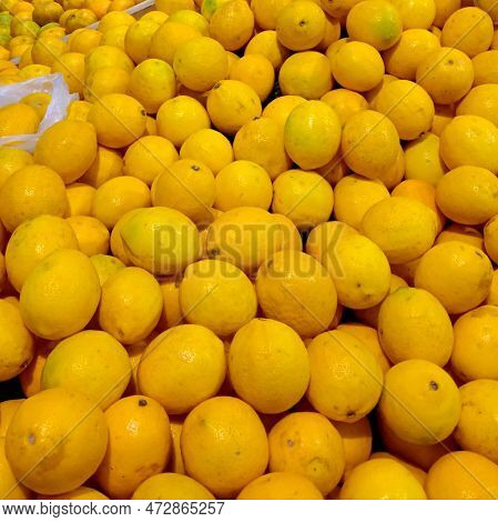 Closeup Of A Display Of Fresh Yellow Lemons At A Market