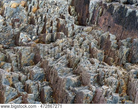 Stone Close-up, Background. Compressed Rock Layers Formation In Various Colors And Thicknesses, Natu
