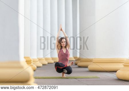 Attractive Young Adult Calm Pretty Woman Wearing Sportswear Working Out Outdoor, Doing Yoga Or Pilat