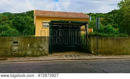 Colares, Lisbon, Portugal - June 3, 2018: A Simple And Empty Colares Bus Stop On The Sidewalk With H