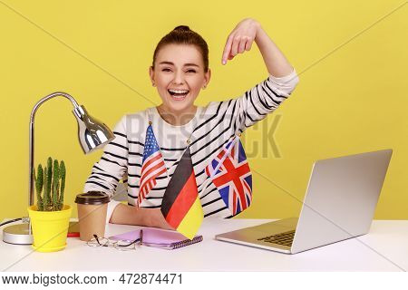 Excited Happy Woman Pointing At Flags Of Usa, German And Great Britain, Bragging With Knowing Of Man