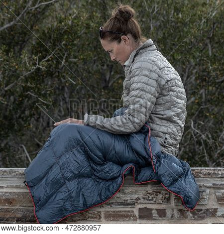 Woman Concentrates On Comptuer Screen While Working Outside