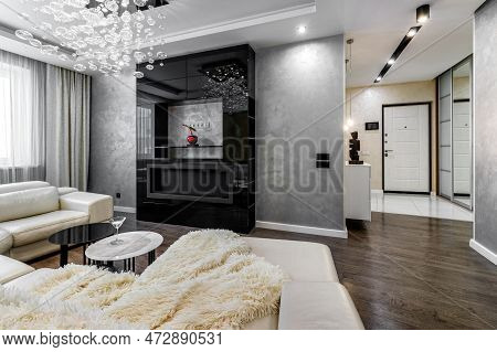 Black Bio Fireplace In The Living Room With Large Crystal Chandelier In The Apartment